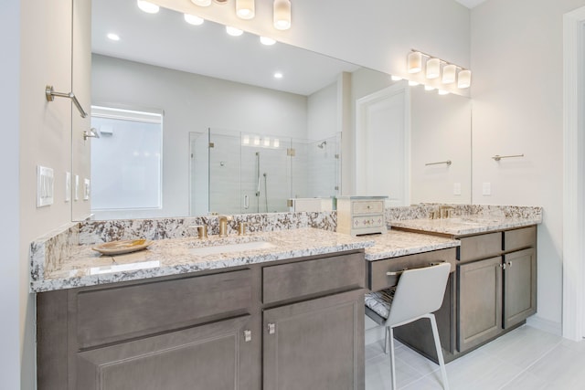 bathroom featuring vanity, tile patterned floors, and a shower with shower door