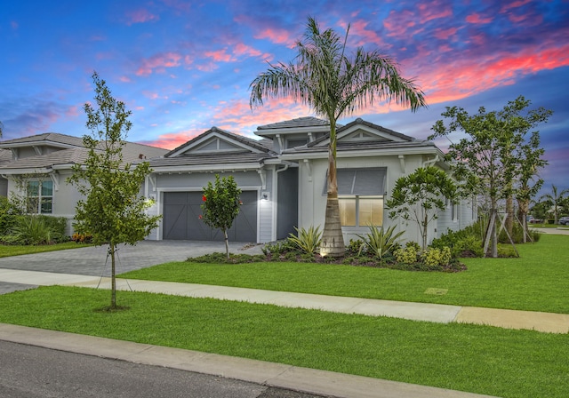 view of front facade featuring a lawn and a garage