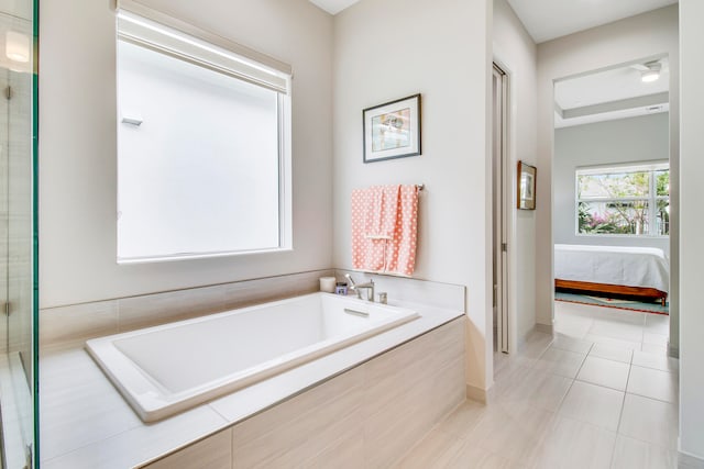 bathroom featuring plus walk in shower and tile patterned floors