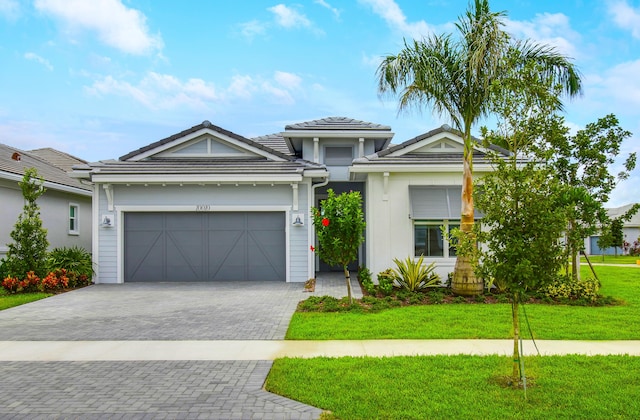 view of front facade featuring a garage and a front lawn