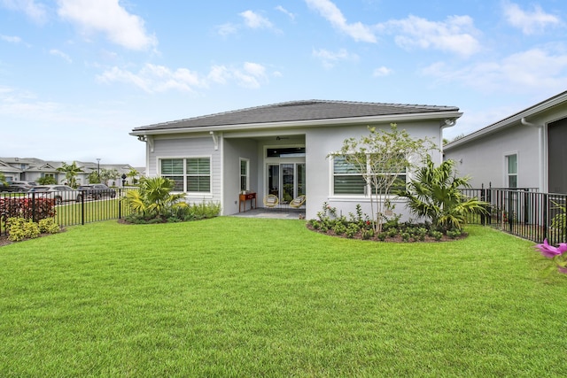 rear view of property with a yard