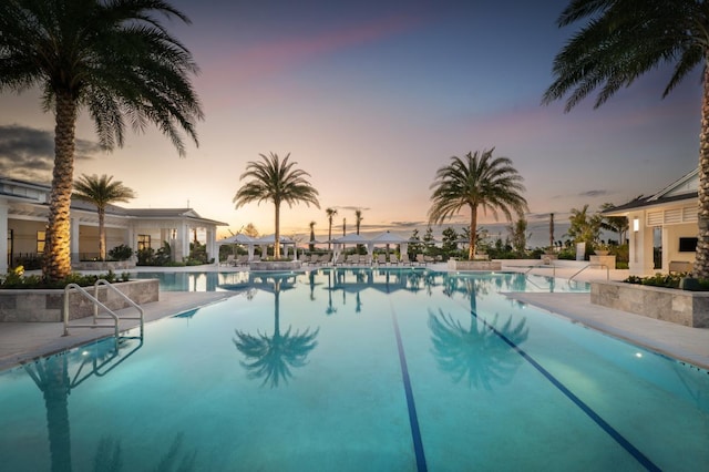 pool at dusk with a patio