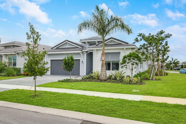 view of front of property featuring a front yard and a garage