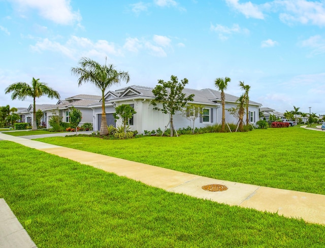 ranch-style home featuring a front lawn and a garage