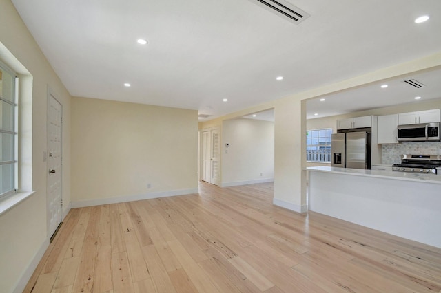 unfurnished living room featuring light hardwood / wood-style floors