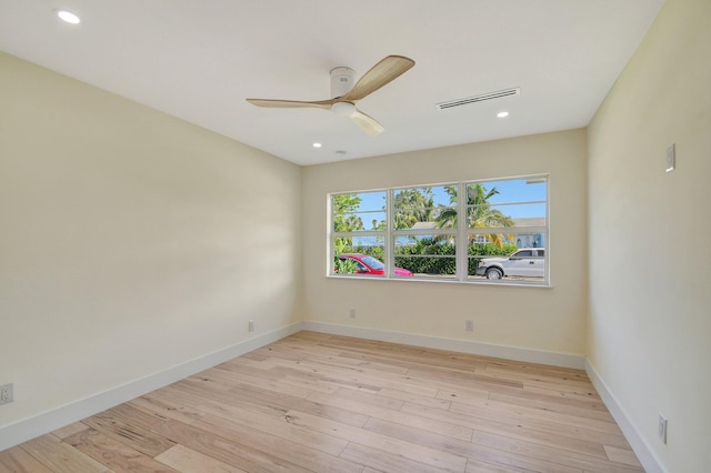 empty room featuring ceiling fan and light wood-type flooring