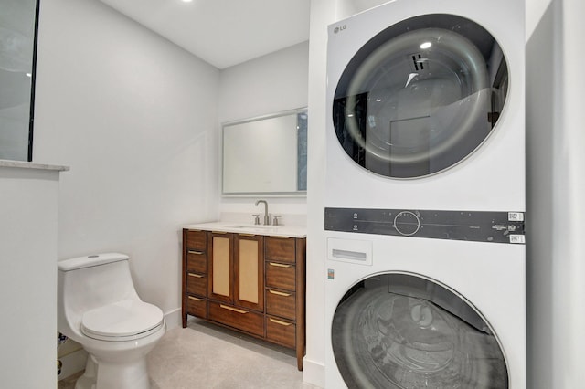 interior space featuring light tile patterned floors, sink, and stacked washer and dryer