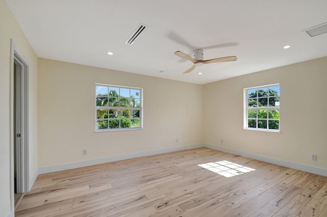 empty room with light wood-type flooring, plenty of natural light, and ceiling fan