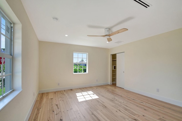 spare room featuring light hardwood / wood-style flooring and ceiling fan