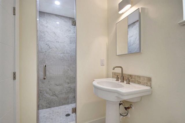 bathroom featuring a shower with shower door