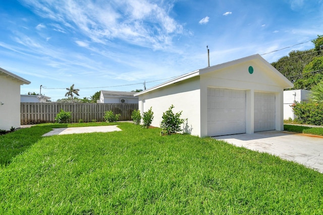 exterior space featuring an outdoor structure, a lawn, and a garage