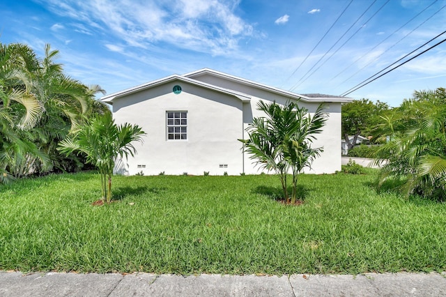 view of side of home featuring a lawn