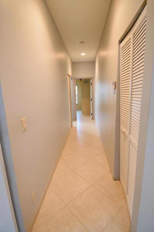 corridor featuring light tile patterned floors