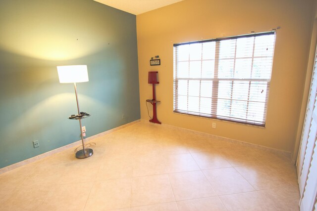 unfurnished room featuring tile patterned flooring