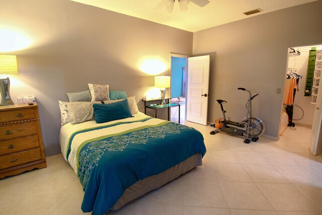 tiled bedroom with ceiling fan