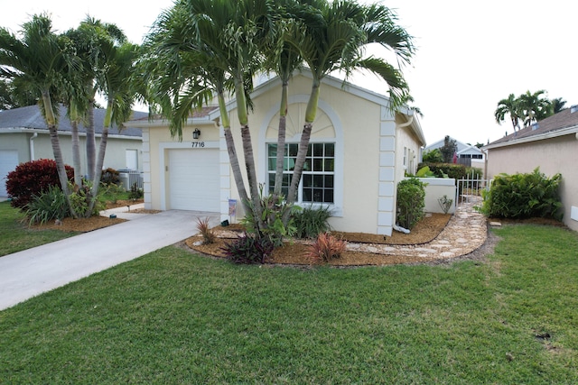 ranch-style house with a garage and a front lawn