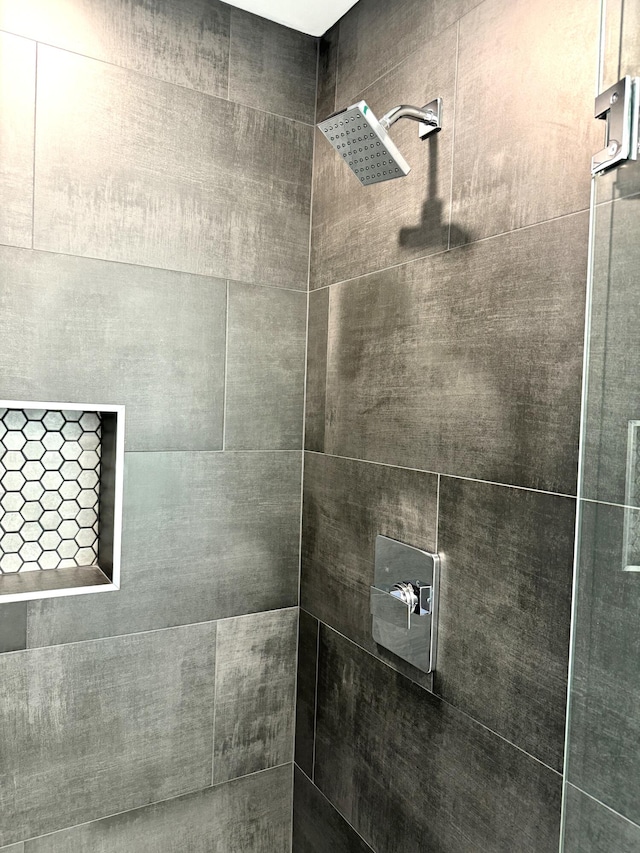 bathroom with a tile shower