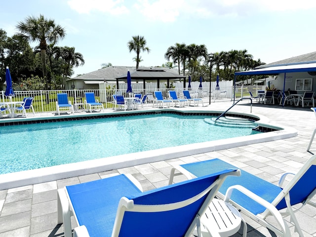 1090 N Dr Unit C, Delray Beach, FL 33445 - community pool with a patio area and fence