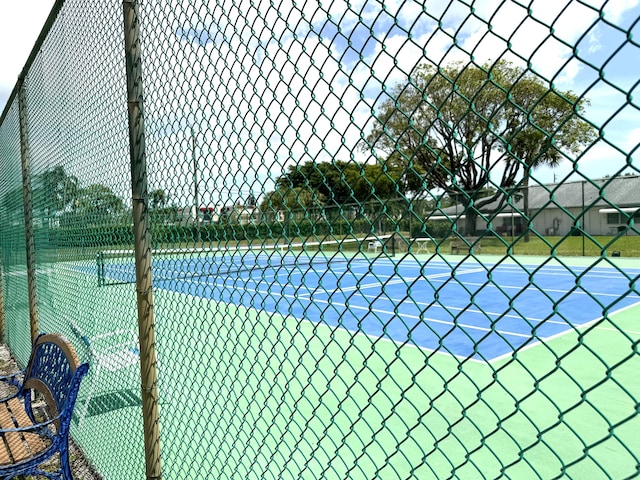 view of sport court with fence