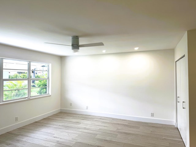 spare room featuring ceiling fan and light hardwood / wood-style floors