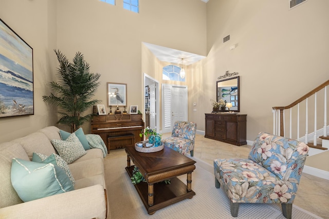 living room featuring a high ceiling and light tile patterned flooring