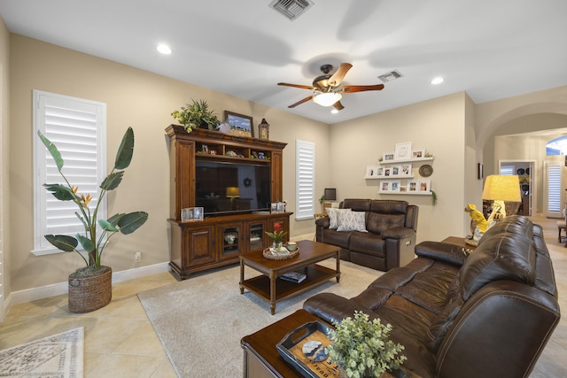 tiled living room with ceiling fan