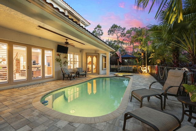 view of swimming pool featuring an in ground hot tub, a patio area, and ceiling fan