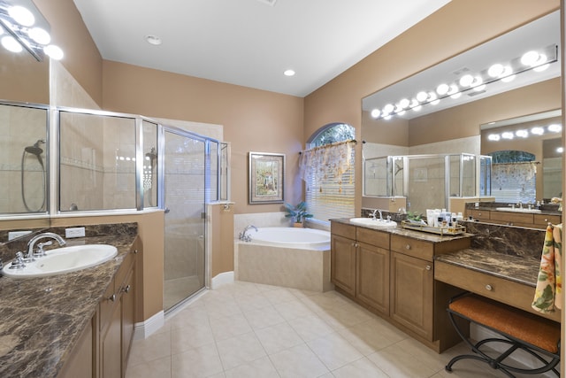 bathroom featuring tile patterned floors, vanity, and shower with separate bathtub