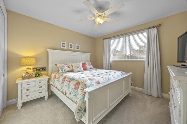 bedroom with ceiling fan and light colored carpet