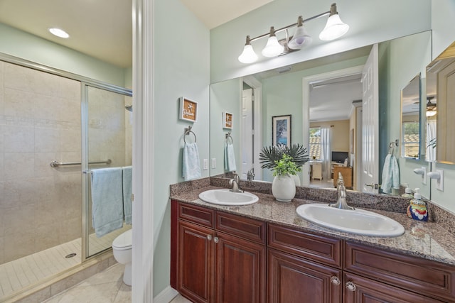 bathroom with toilet, tile patterned floors, walk in shower, and vanity