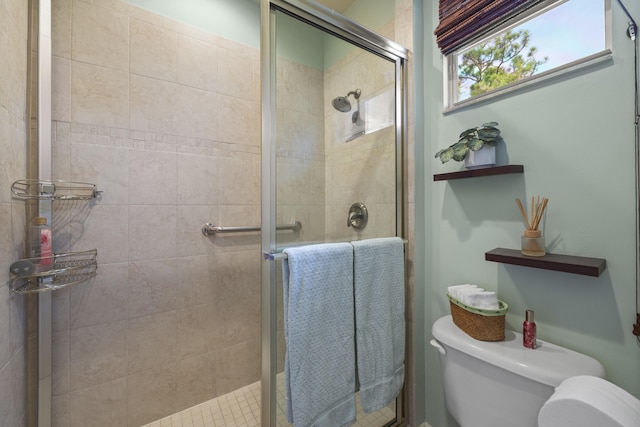 bathroom with toilet and walk in shower