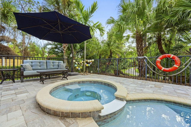 view of swimming pool with a patio area and an in ground hot tub