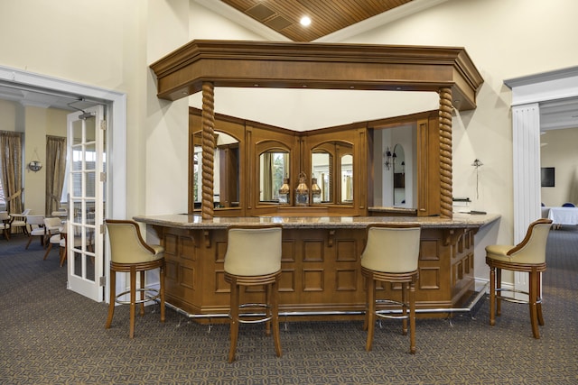 bar featuring dark colored carpet, high vaulted ceiling, and wooden ceiling