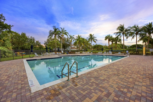 pool at dusk with a patio