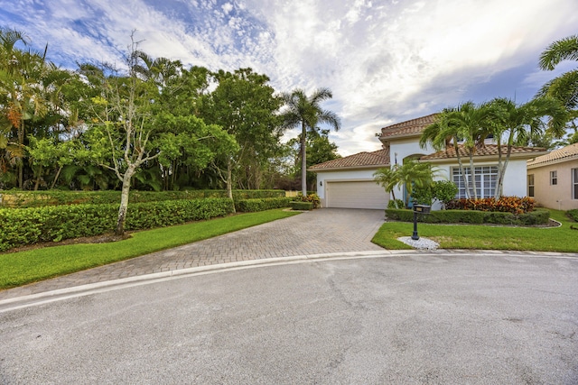 view of front of property with a garage and a front yard