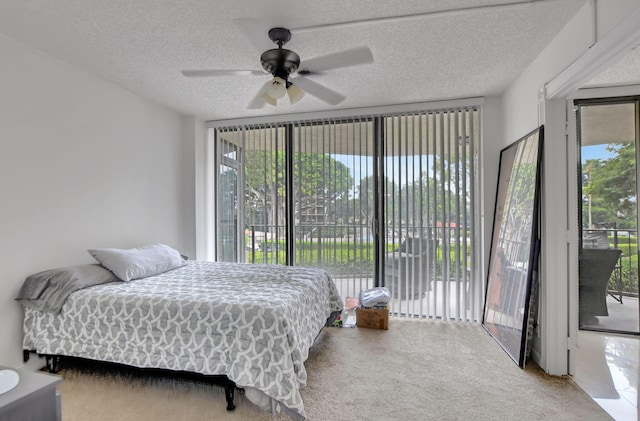 carpeted bedroom featuring a textured ceiling, ceiling fan, and access to exterior