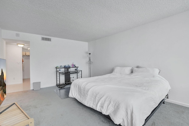 carpeted bedroom with a textured ceiling