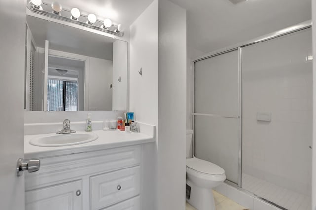 bathroom with tile patterned floors, toilet, walk in shower, and vanity