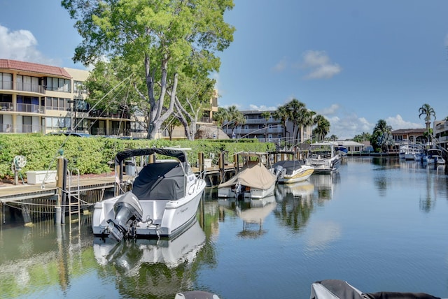 view of dock with a balcony and a water view