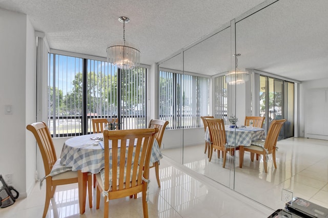 tiled dining space with an inviting chandelier, a textured ceiling, and expansive windows