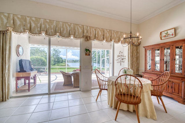 dining space with light tile patterned floors, ornamental molding, and a notable chandelier