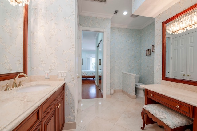 bathroom with tile patterned floors, toilet, vanity, and ornamental molding