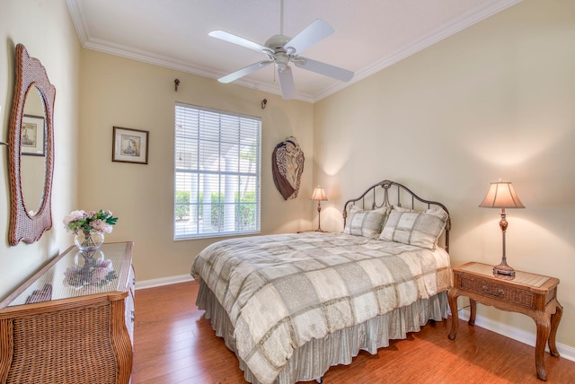 bedroom featuring hardwood / wood-style flooring, ceiling fan, and ornamental molding