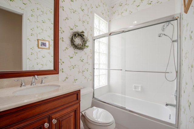 full bathroom with vanity, toilet, and shower / bath combination with glass door