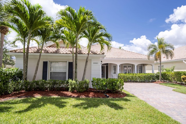 mediterranean / spanish house with a front yard