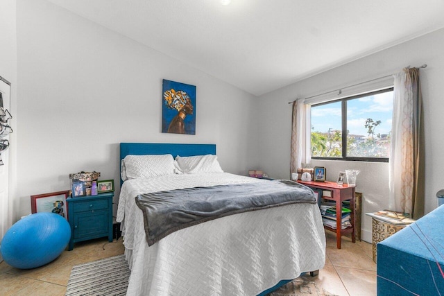 bedroom featuring lofted ceiling and light tile patterned floors