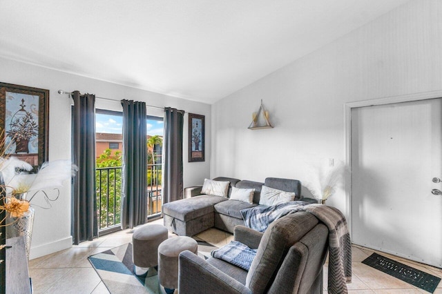 living room featuring lofted ceiling and light tile patterned floors