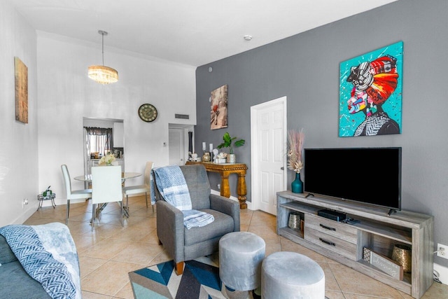 living room featuring an inviting chandelier and light tile patterned flooring