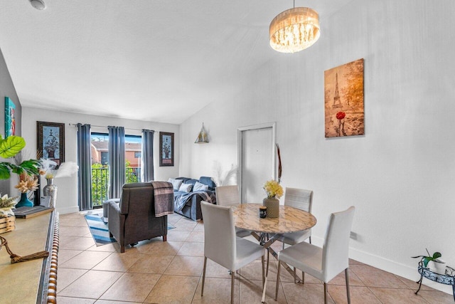 dining space with vaulted ceiling, light tile patterned floors, and a notable chandelier