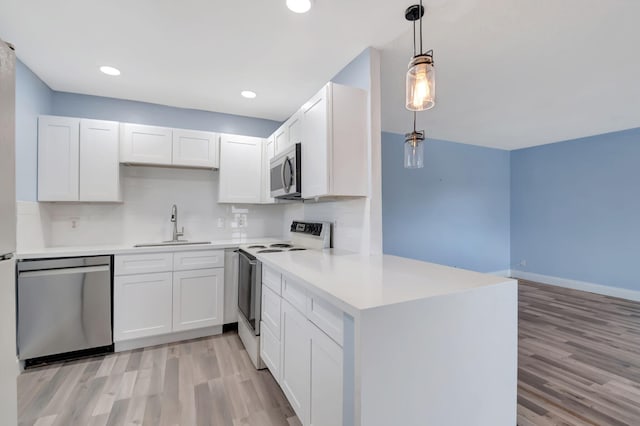 kitchen featuring light wood-type flooring, white cabinetry, and appliances with stainless steel finishes